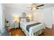 Bedroom with queen-size bed and wood flooring at 8318 Quimby Cir, Davenport, FL 33896