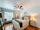 Main bedroom with king-size bed and wood flooring at 8318 Quimby Cir, Davenport, FL 33896