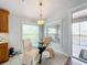 Bright breakfast nook with glass table and chairs near balcony at 8318 Quimby Cir, Davenport, FL 33896