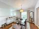Modern dining room featuring glass table and hardwood floors at 8318 Quimby Cir, Davenport, FL 33896