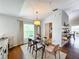 Bright dining room with glass table, hardwood floors, and window at 8318 Quimby Cir, Davenport, FL 33896