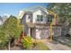 Two-story townhome with two-car garage and nicely landscaped front yard at 8318 Quimby Cir, Davenport, FL 33896