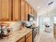 Granite countertops and wood cabinets in this well-equipped kitchen at 8318 Quimby Cir, Davenport, FL 33896