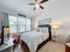 Bright main bedroom with king bed and large window at 8318 Quimby Cir, Davenport, FL 33896