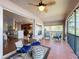 Spacious screened balcony with seating and partial kitchen view at 8318 Quimby Cir, Davenport, FL 33896