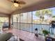 Relaxing screened balcony overlooking a lake and lush landscape at 8318 Quimby Cir, Davenport, FL 33896