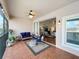 Relaxing screened balcony with patio furniture and view of living area at 8318 Quimby Cir, Davenport, FL 33896