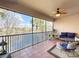 Spacious screened balcony with lake view and patio furniture at 8318 Quimby Cir, Davenport, FL 33896
