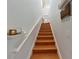Modern wooden staircase with white walls and small shelves at 8318 Quimby Cir, Davenport, FL 33896
