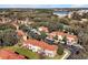 Aerial view of townhouses with red tile roofs and lush landscaping at 8552 Crystal Cove Loop, Kissimmee, FL 34747