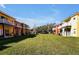 Aerial view of a community of colorful townhouses with well-maintained lawns at 8552 Crystal Cove Loop, Kissimmee, FL 34747