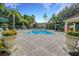 Community pool area with lush landscaping and planters at 8552 Crystal Cove Loop, Kissimmee, FL 34747