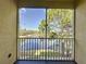 Screened balcony overlooking a peaceful lake and trees at 8803 Dunes Ct # 306, Kissimmee, FL 34747