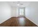 Bright bedroom with ceiling fan and dark wood-look tile floor at 8803 Dunes Ct # 306, Kissimmee, FL 34747