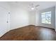 Bright bedroom with wood-look floors, ceiling fan, and access to a bathroom at 8803 Dunes Ct # 306, Kissimmee, FL 34747