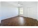 Well-lit bedroom with ceiling fan and dark wood-look tile floor at 8803 Dunes Ct # 306, Kissimmee, FL 34747