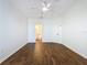 Bedroom with wood-look floors, ceiling fan, and bathroom access at 8803 Dunes Ct # 306, Kissimmee, FL 34747