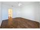 Spacious bedroom with dark wood floors and an ensuite bathroom at 8803 Dunes Ct # 306, Kissimmee, FL 34747