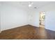 Bedroom with wood-look floors, ceiling fan, and bathroom access at 8803 Dunes Ct # 306, Kissimmee, FL 34747
