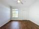 Bedroom with wood-look floors, large window, and ceiling fan at 8803 Dunes Ct # 306, Kissimmee, FL 34747