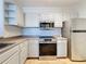 Bright kitchen with stainless steel appliances and white cabinets at 8803 Dunes Ct # 306, Kissimmee, FL 34747