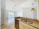Open kitchen with stainless steel appliances and view to living room at 8803 Dunes Ct # 306, Kissimmee, FL 34747