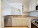 Updated kitchen featuring stainless steel appliances and light cabinets at 8803 Dunes Ct # 306, Kissimmee, FL 34747
