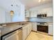 Modern kitchen with stainless steel appliances and white cabinets at 8803 Dunes Ct # 306, Kissimmee, FL 34747