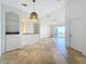 Open living room and kitchen with tile floors and neutral colors at 8803 Dunes Ct # 306, Kissimmee, FL 34747