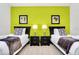 Two twin beds in a room with lime green walls at 5192 Oakbourne Ave, Davenport, FL 33837
