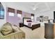 Bedroom with king bed, lavender walls, and sitting area at 5192 Oakbourne Ave, Davenport, FL 33837