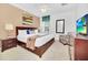 Bedroom with king bed, wood furniture, and a large TV at 5192 Oakbourne Ave, Davenport, FL 33837