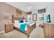 King-size bed, wood furniture, and teal bedding in bedroom at 5192 Oakbourne Ave, Davenport, FL 33837