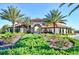 Resort-style entrance with lush landscaping and palm trees at 5192 Oakbourne Ave, Davenport, FL 33837