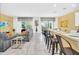 Open kitchen with granite countertops, white cabinets, and black appliances at 5192 Oakbourne Ave, Davenport, FL 33837
