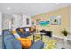 Living room with gray couches, orange pillows, and a large TV at 5192 Oakbourne Ave, Davenport, FL 33837