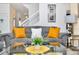 Gray sofa with orange pillows in a living room with a glass coffee table at 5192 Oakbourne Ave, Davenport, FL 33837