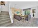 Spacious living room with gray sectional sofa and view of staircase at 5192 Oakbourne Ave, Davenport, FL 33837
