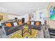 Spacious living room with gray sofas, orange pillows, and a large TV at 5192 Oakbourne Ave, Davenport, FL 33837
