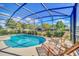 Inviting kidney-shaped pool with lounge chairs at 5192 Oakbourne Ave, Davenport, FL 33837