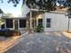 Spacious backyard with stone patio, screened in porch and basketball hoop, perfect for relaxing and entertaining at 12212 Holly Jane Ct, Orlando, FL 32824