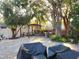 Secluded backyard space showcasing brick paver patio, pergola seating, and mature trees for shade and privacy at 12212 Holly Jane Ct, Orlando, FL 32824