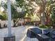 Backyard with brick paver patio featuring a pergola seating area and mature trees providing ample shade at 12212 Holly Jane Ct, Orlando, FL 32824