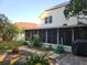 Well-maintained backyard with stone pathway, brick paver patio, screened lanai, and lush landscaping at 12212 Holly Jane Ct, Orlando, FL 32824
