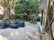 Relaxing backyard patio with pavers, covered seating area, and lush landscaping at 12212 Holly Jane Ct, Orlando, FL 32824