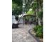Large backyard patio with pergola, seating area, and lush landscaping at 12212 Holly Jane Ct, Orlando, FL 32824