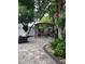 Landscaped backyard features a pergola and patio, offering a tranquil outdoor retreat at 12212 Holly Jane Ct, Orlando, FL 32824