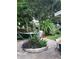 Beautiful backyard featuring garden and brick patio with hammock and barbeque grill at 12212 Holly Jane Ct, Orlando, FL 32824