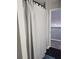 Bathroom with a tub-shower combo and gray and white waffle weave shower curtain at 12212 Holly Jane Ct, Orlando, FL 32824