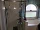 Bathroom with shower and separate tub beneath arched window and curtain at 12212 Holly Jane Ct, Orlando, FL 32824